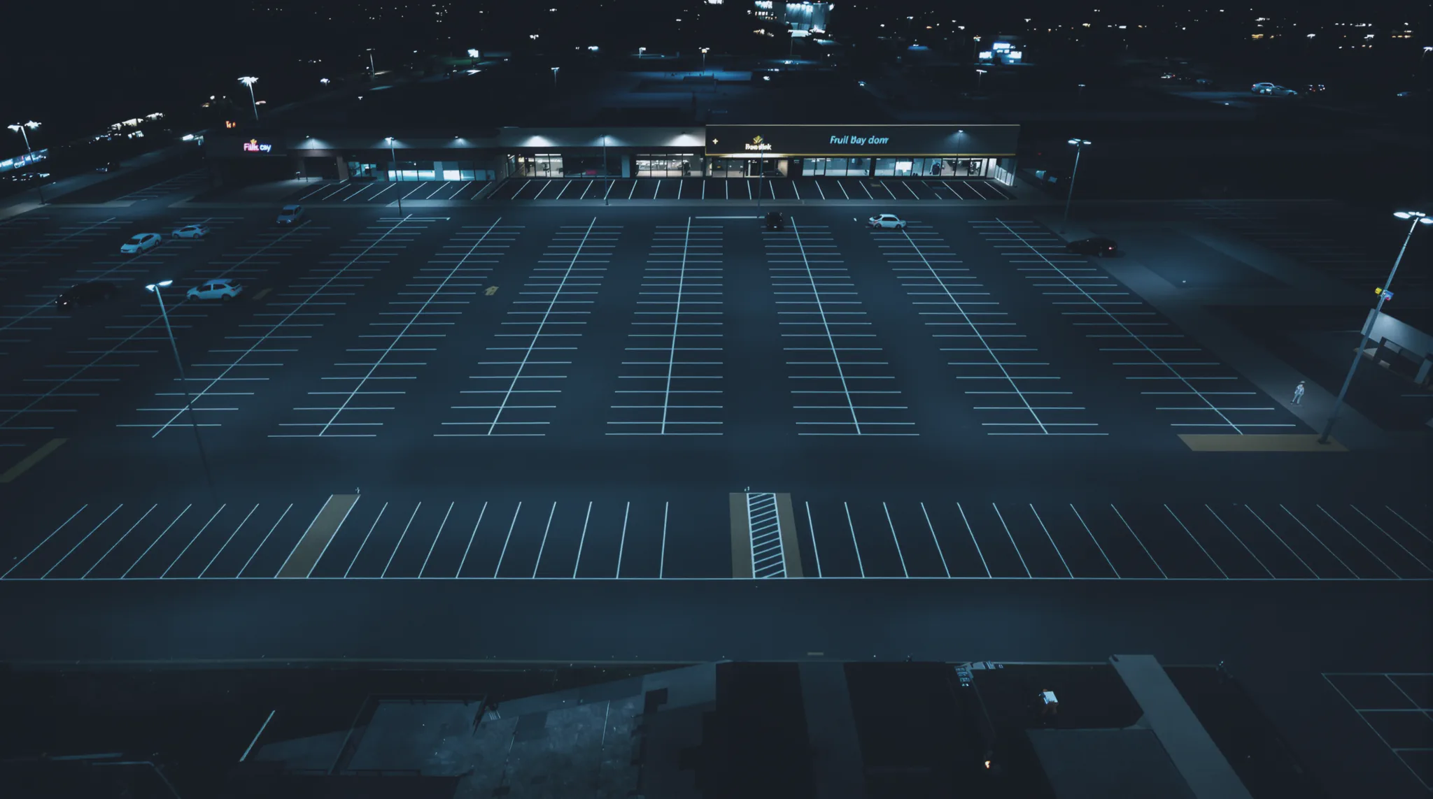 High-angle drone view of an open site at night.